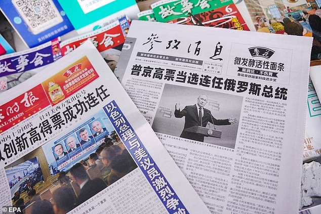 Reports in Chinese newspapers about Putin's re-election as President of the Russian Federation are displayed at a kiosk in Beijing, China, March 19, 2024
