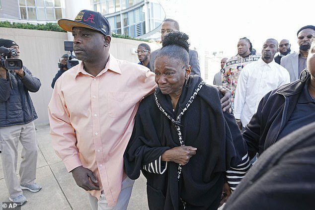 Eddie Terrell Parker, left, accompanies Mary Jenkins, mother of Michael Corey Jenkins, to the Thad Cochran United States Courthouse in Jackson on Tuesday