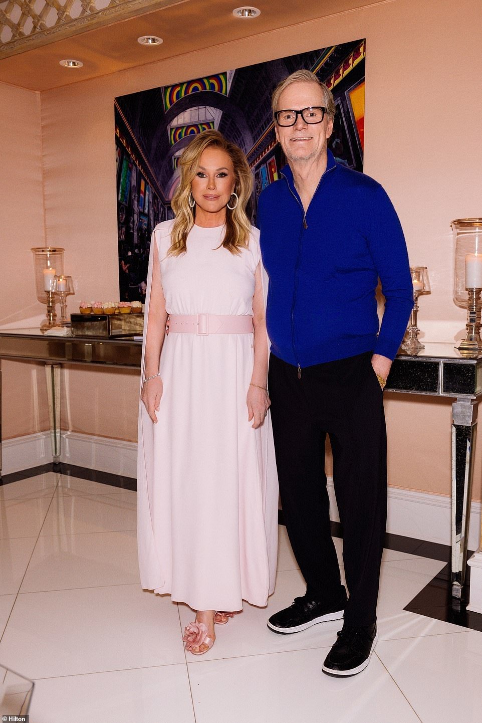 Kathy wore a white dress with pink shoes as she posed with her husband Rick Hilton of Hilton & Hilton