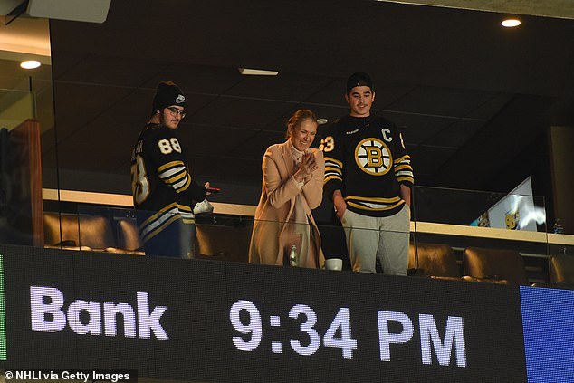 Dion attended the game in Boston with her sons, who were also in the locker room with her