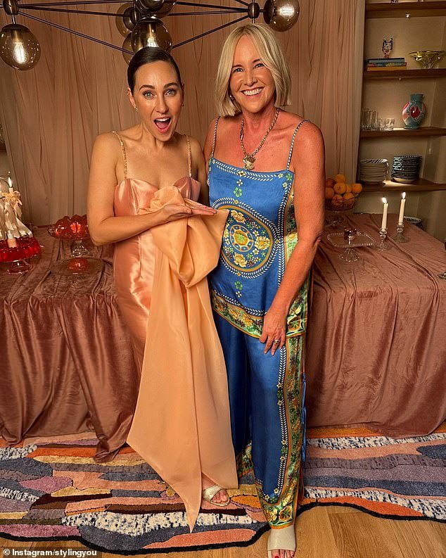 She cut a glamorous figure in a stunning peach satin dress at the party, where she was joined by her friends including designer Nikki Parkinson.