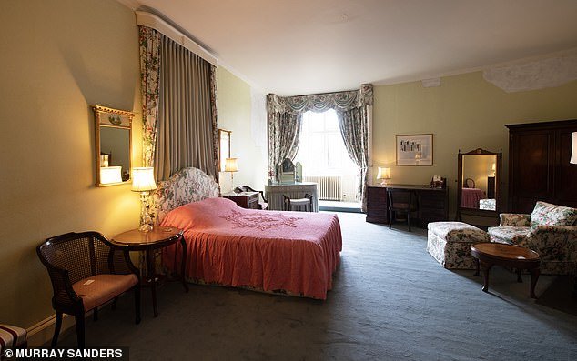 The Queen Mother's Bedroom, where the floral patterns are most florid, with pink roses cascading down the cornice, swags, headboard and curtains