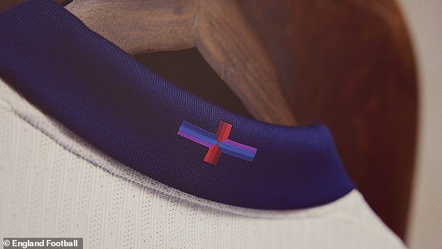 The shirt features a modified design of the St. George's Cross, which has a red, navy blue and purple design