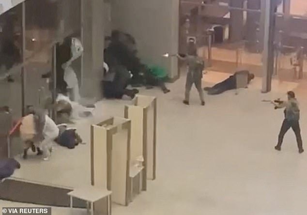 Several armed men stormed into a major concert hall in Moscow and fired automatic weapons into the crowd, wounding more than 100 people and starting a massive fire in an apparent terror attack.