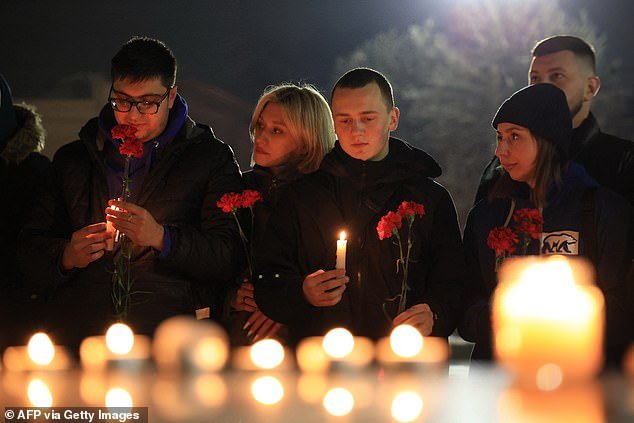 People lay flowers and light candles in memory of the victims of the Moscow gun attack