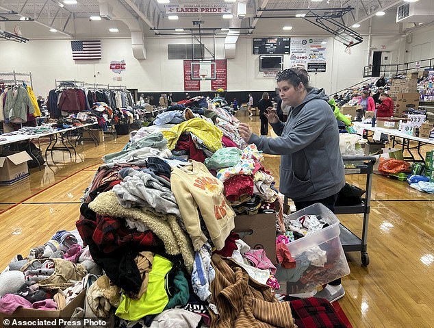 A woman searches clothing at Indian Lake High School on Saturday, March 16, 2024 in Indian Lake, Logan County, Ohio