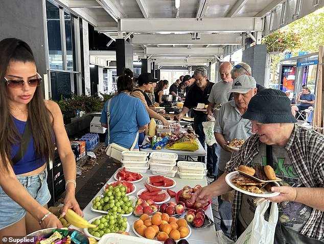 Mr Mezei, along with his staff and family, volunteer every second Sunday to help the Chopping Circle - a charity that provides food to homeless and food-stressed households - in Martin Place (pictured)