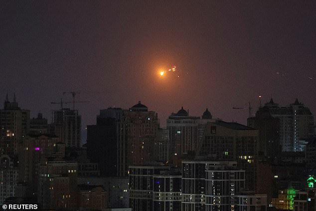 A rocket explosion is seen in the skies over Kiev during a Russian missile attack on March 24