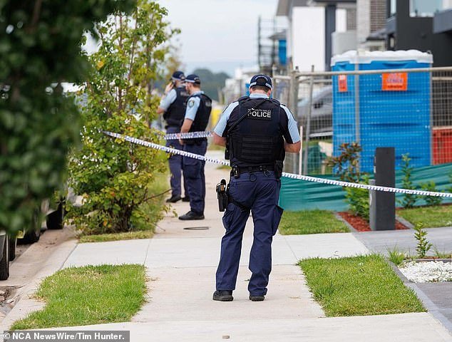NSW Police allege Fletcher murdered Mr Evennett and dumped his body 700 meters down the road from their new home (pictured, officers at Melonba home)