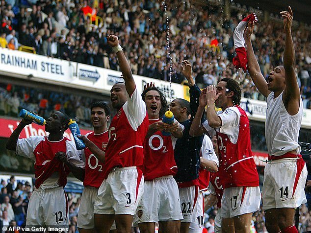 Cole (third from left) was an integral part of the Arsenal team that went unbeaten throughout the 2003–04 Premier League season