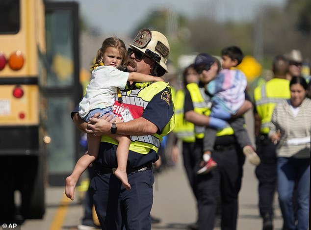 A little girl is transported Friday after a fatal school bus crash on Texas State Highway 21 near Caldwell Road