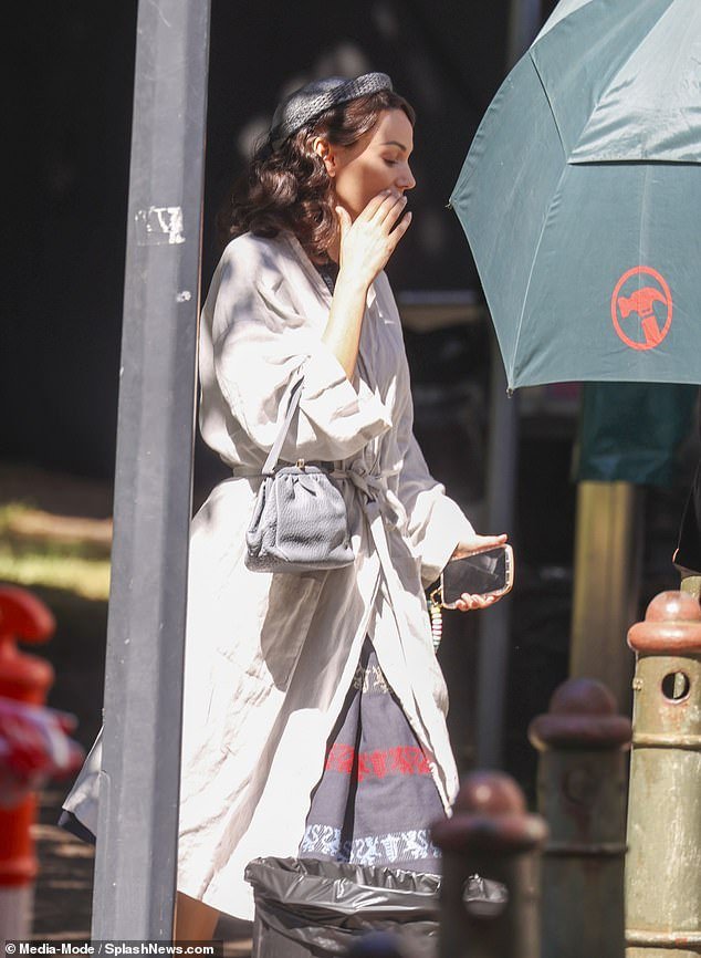 She wore flip-flops and carried a light blue bag as she left the makeup trailer and headed to the set