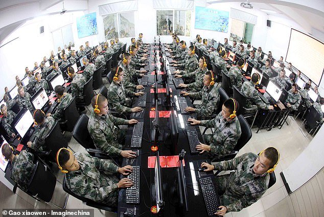 A stock photo of Chinese soldiers watching online news at a computer facility