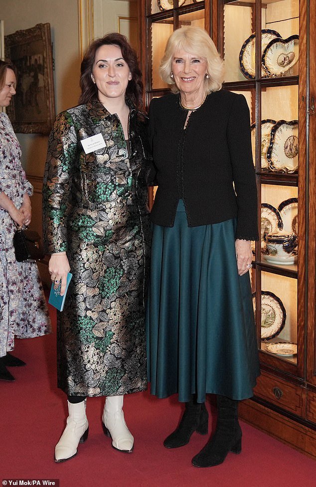 Queen Camilla tonight approved new research showing that five minutes of reading a day is as valuable to health and wellbeing as walking 10,000 steps and eating five portions of fruit and vegetables.  Pictured with Vicki Perrin