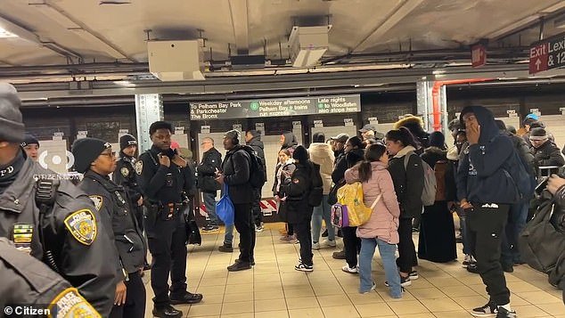 Concerned commuters line the 125th Street station after a fatal pushing incident occurred Monday evening