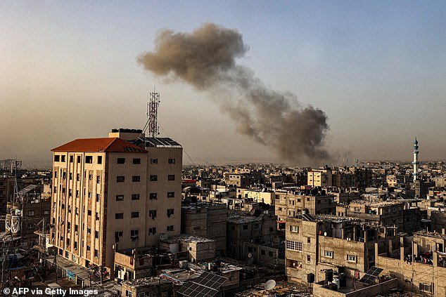 Smoke pours over buildings after the Israeli bombing of Rafah