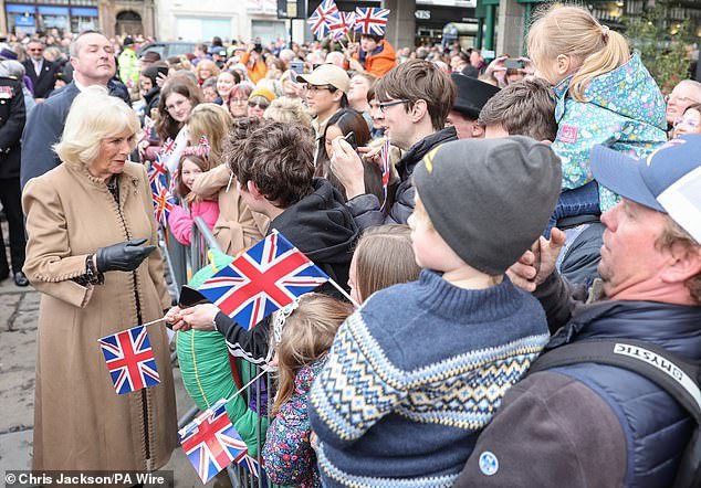 Queen Camilla smiles in Shrewsbury as she meets the public during her visit to the farmers market