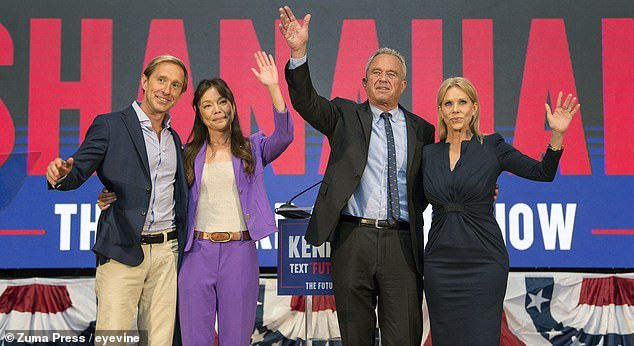 Robert F. Kennedy Jr.  (center right) and his actress wife Cheryl Hines (right) on stage in Oakland Tuesday with his new running mate Nicole Shanahan (center left) and her partner Jacob Strumwasser (left)