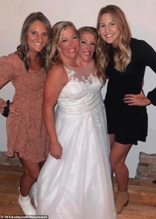 Here's Abby stunning in a floor-length white dress on her wedding day