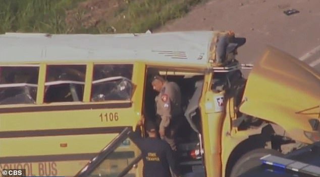 Officers are seen examining the wreckage of the school bus after the incident last week