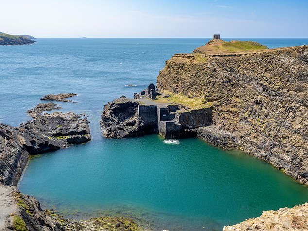 See the Porthgain Blue Lagoon in Pembrokeshire, Wales, which can be reached by foot or by sea.  Ordnance Survey recommends taking a walk on the nearby cliffs for 'breathtaking views'.  Operating System Grid Reference: SM 79483 31496