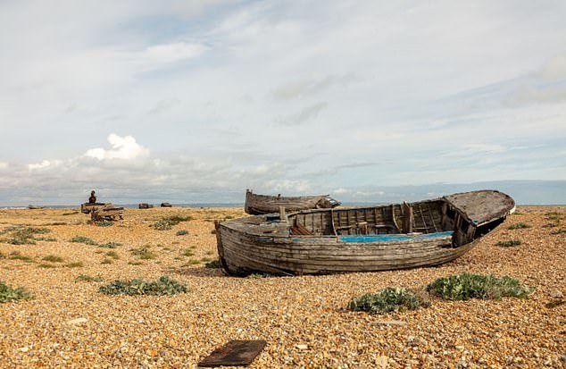 Dungeness in Kent is sometimes called Britain's only desert.  It is a small fishing village with a 'surreal' landscape full of abandoned boats and fishing huts.  There is also a disused railway line.  OS grid reference: TR 08901 16953