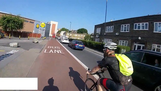 However, the cyclist behind him berates him and says: 'If you're afraid, you shouldn't ride on the damn road'
