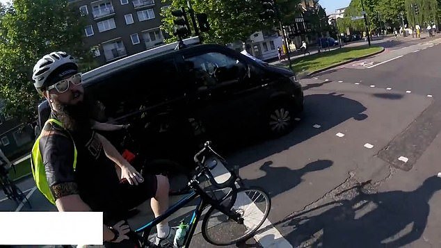 People on social media wondered why the bearded man pictured encouraged the cyclist to risk his life