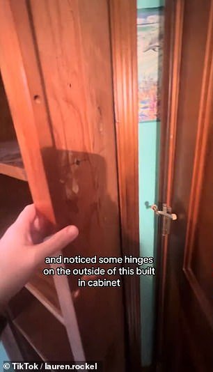 She discovered the hidden entrance by discovering exposed hinges on the outside of a bathroom cabinet