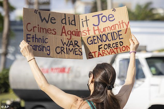 A demonstrator holds a sign during a protest against U.S. Vice President Kamala Harris' visit to San Juan, Puerto Rico.