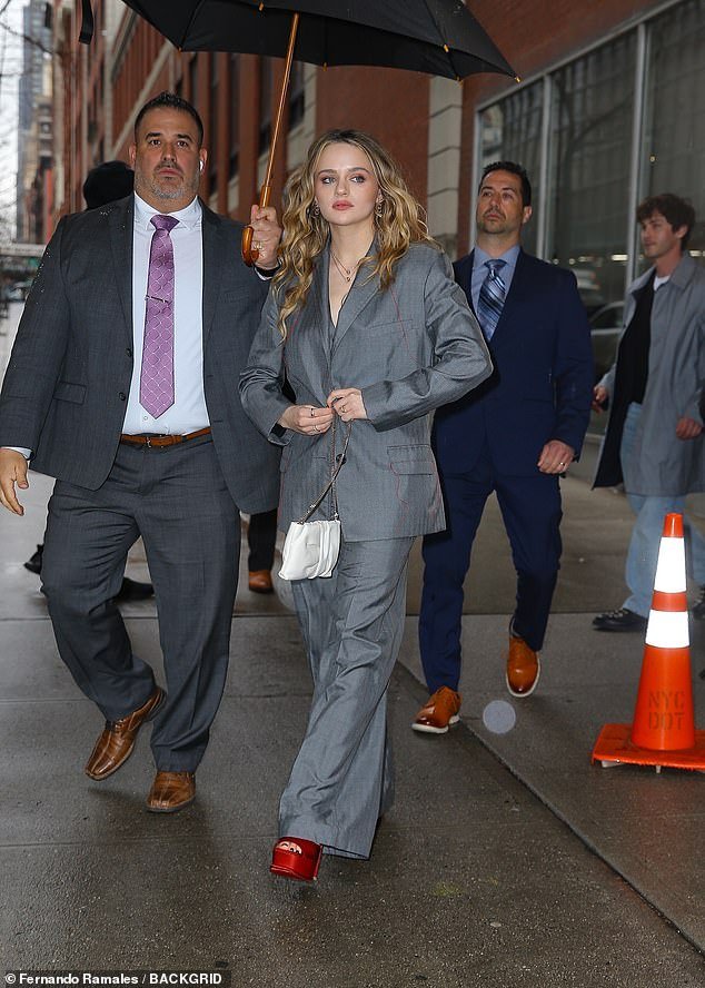 The InBetween star wore an oversized gray suit with a pair of red platform heels