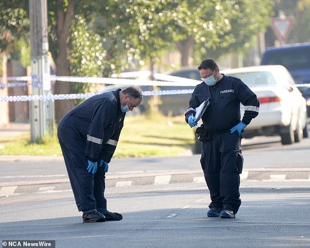 The forensic police search the street for clues that could lead to the shooter