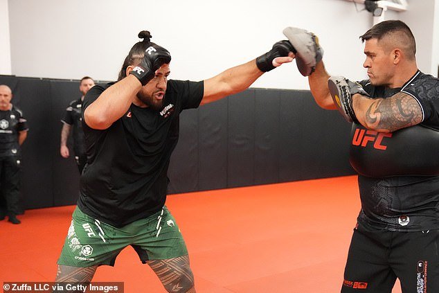 Tuivasa (pictured left during training) has spectacularly knocked out thirteen opponents en route to a 14-7 MMA record