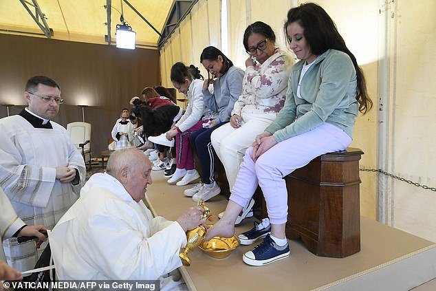 Pope Francis performs the "Washing the feet" of prisoners during a private visit to the prison