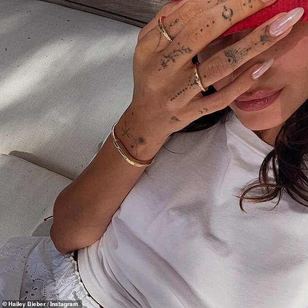 Hailey held up her phone to grab the assortment of snaps, while also showing off a gold bracelet on her right wrist and a pair of rings on her hand