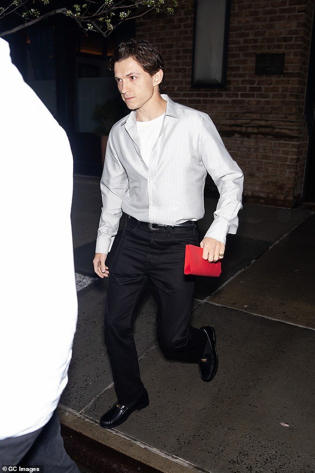 The British heartthrob wore a white Oxford shirt and black trousers
