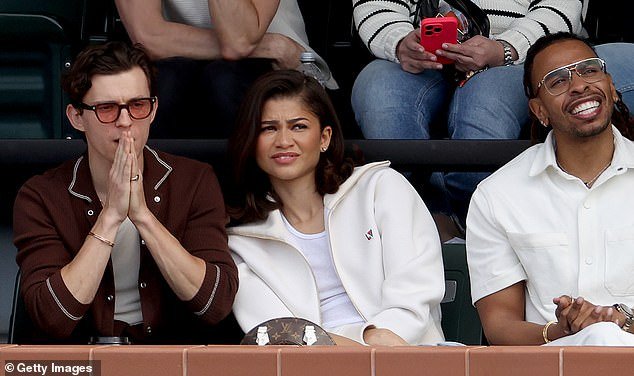 Sitting in the stands, a polo-clad Tom looked handsome as he snuggled up to his girlfriend