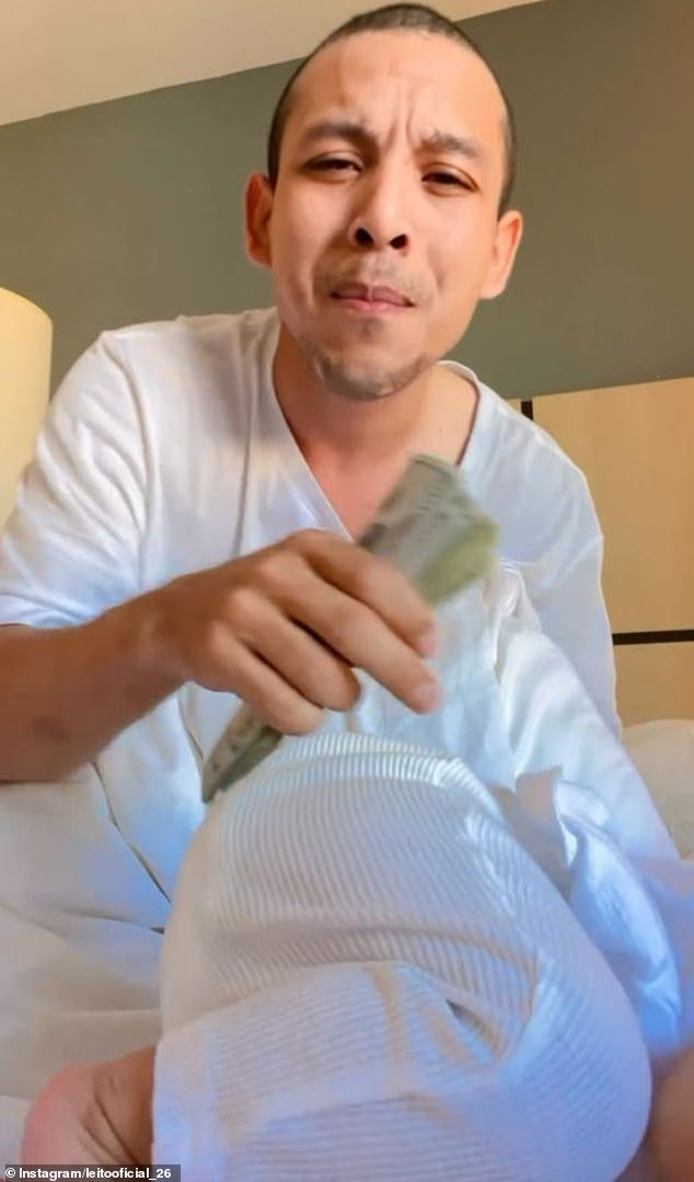 Leonel Moreno, 27, sings Spanish lyrics and waves a stack of $100 bills at the camera as the child rocks back and forth without support and at one point even face-plants