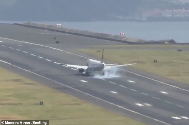 A cloud of smoke appeared around the wheels of the plane as it finally made contact with the runway