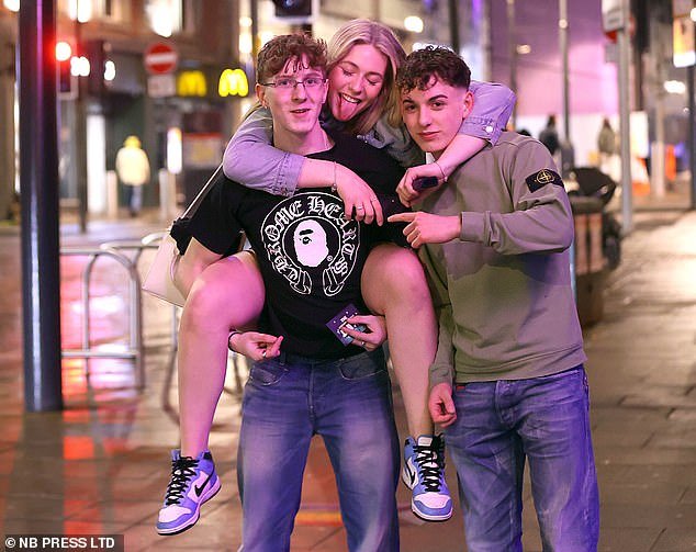 LEEDS: A man in a Stone Island jacket desperately tries to 'get the badge in' as his friends pose
