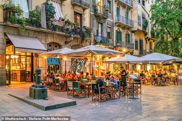 File photo shows an open-air tapas restaurant with parasols in Barcelona, ​​Catalonia