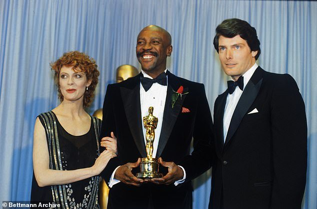 Gossett Jr celebrates his 1982 Oscar win with actress Susan Sarandon (left) and Superman star Christopher Reeve (right)
