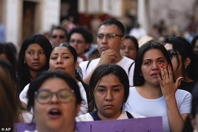 A woman wipes her tears during a demonstration against the kidnapping and murder of an 8-year-old girl in the main square of Taxco, Mexico