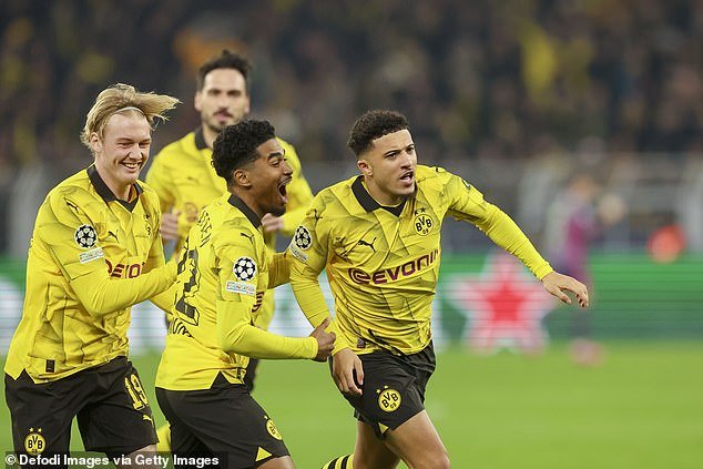 Jadon Sancho celebrates with teammates after giving Borussia Dortmund an early lead against PSV Eindhoven in the Champions League on Wednesday evening