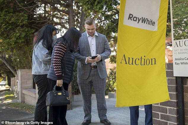 Immigration in the year to September accounted for 83 percent of Australia's population growth, with a record 548,800 migrants and just 111,000 net births (pictured is an auction in Sydney)