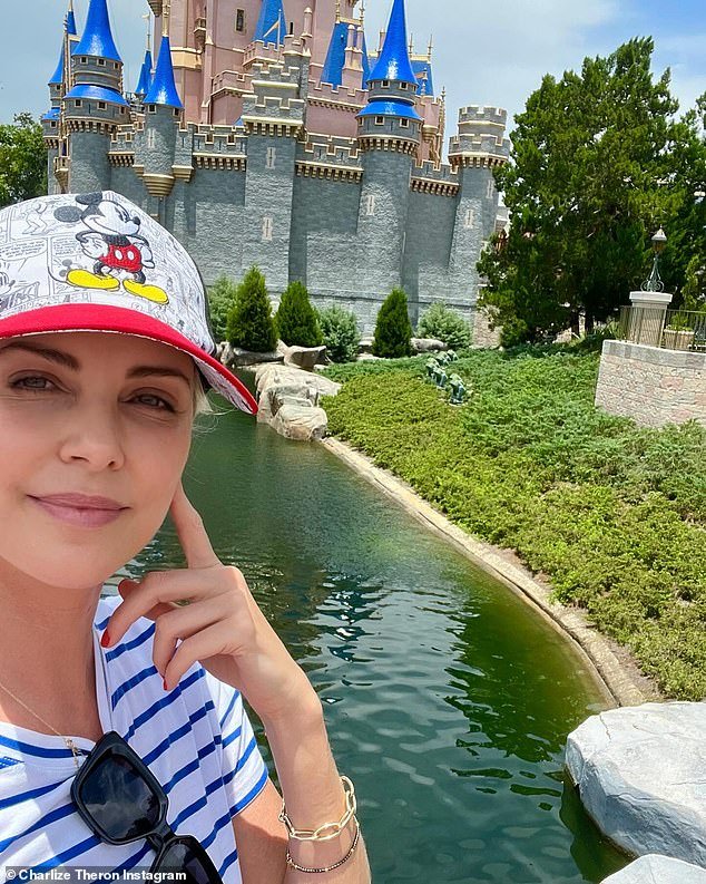 Charlize Theron, 48, posted three photos to Instagram on Wednesday from a Disney World vacation she spent in Florida with her daughters Jackson, 11, and August, seven.  She posed in front of the Cinderella Castle at the amusement park