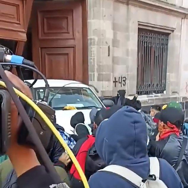 Protesters were captured on video pushing a pickup truck before breaking through the door of the National Palace in Mexico City on Wednesday