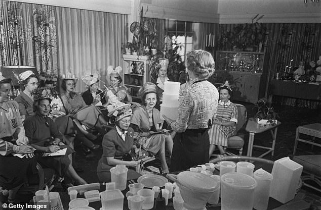 A group of unnamed women attend a Tupperware party circa 1955, some wearing hats made from Tupperware products