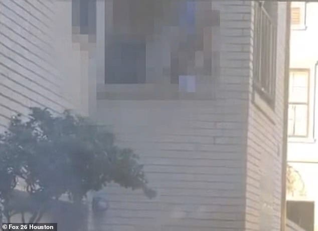 A couple is seen having sex on the balcony of a Houston Airbnb in a pixelated image from a shocked local resident