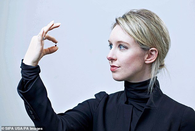 Holmes, then 29, is photographed in 2014 holding a nanotainer of blood at Theranos headquarters in Palo Alto, California, before she was convicted of fraud